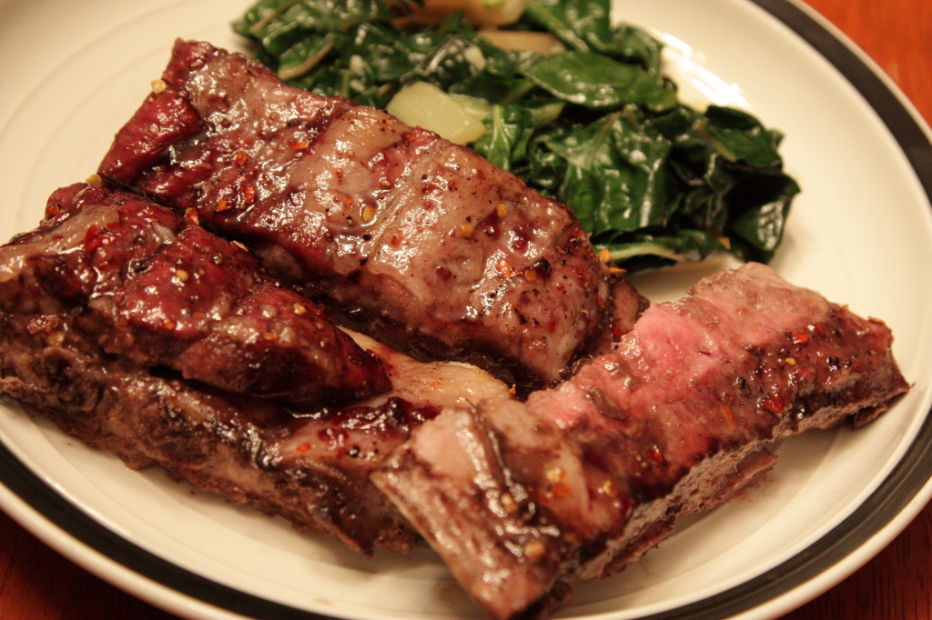 Apple cider glazed baby back ribs served with sauteed chard