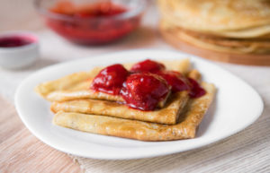 gluten-free crepe recipe shown with strawberry sauce